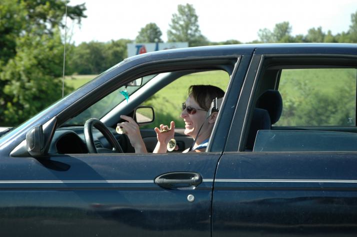 some odd lady playing her prayer bells while driving - 